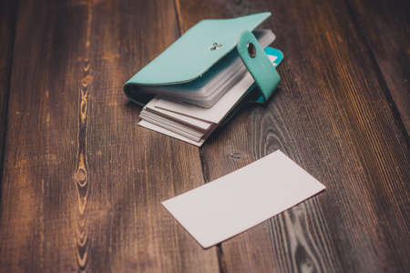 blue wallet on a wooden table business cards coin pocketの写真素材