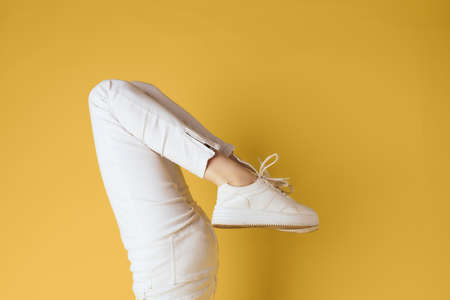 Inverted womens legs sneakers fashion studio street styleの写真素材