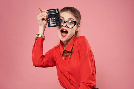 Elegant woman red shirt secretary finance pink backgroundの写真素材