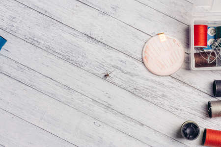multicolored thread pins on a wooden table sewing accessories Copy Spaceの写真素材