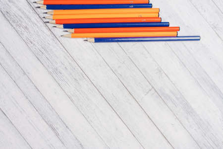 watercolor paints and colored pencils on a wooden table Copy Spaceの写真素材