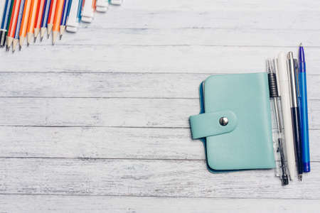 business card holder and pens pencils on a wooden table office financeの写真素材