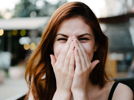 Portrait of a happy woman at a table in a cafe close-up makeup model