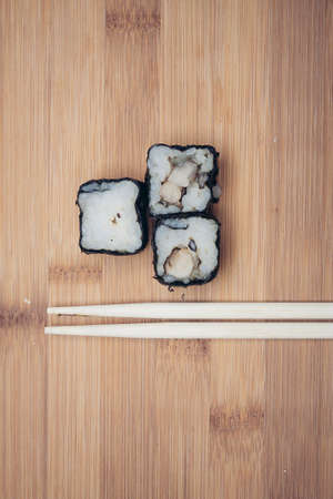 sushi rolls chopsticks food ration delicacy wood board japanese cuisineの写真素材