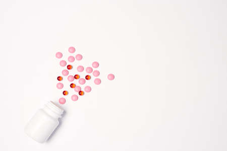 White jar with pills on a light background top view medicine health vitaminsの写真素材