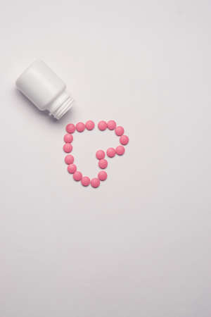 White jar with pills on a light background top view medicine health vitaminsの写真素材
