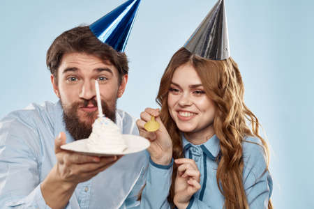 Birthday corporate young man and woman with cake on isolated background disco partyの写真素材