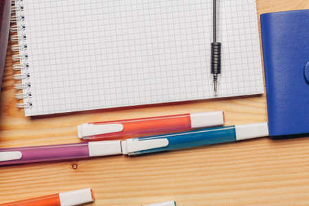 glasses notepads markers stationery office wooden tableの写真素材