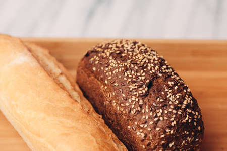 white dark bread whole grain homemade cakes wooden tray breakfastの写真素材