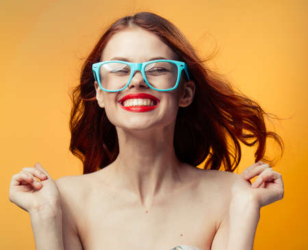 beautiful woman with red lips over isolated background naked shoulders red hairの写真素材