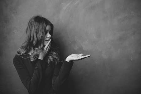 portrait of a young woman with a cloth on her head and gesturing with her hands Copy Spaceの写真素材