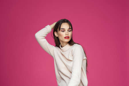 Woman with long hair and red lips white blouse pink background attractive lookの写真素材