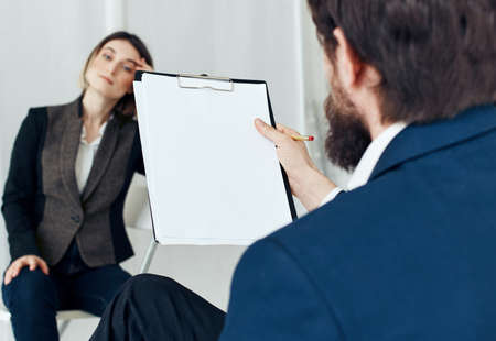 Business man communicates with a woman in a suit, staff vacancies resumeの写真素材