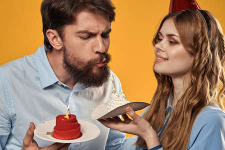 Birthday party man and woman fun yellow background cap holidayの写真素材