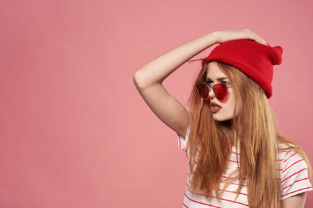 Beautiful fashionable woman in red hat with sunglasses Studioの写真素材