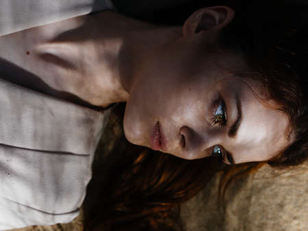 Woman lies on sand resting fresh air summer sunの写真素材