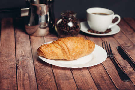 crispy fresh croissants on a plate on the table breakfast dessertの写真素材
