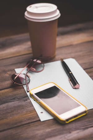 office desk documents notepad glasses mobile phone coffee cupの写真素材