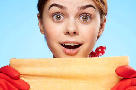 cleaning lady in rubber gloves holding a rag in her hands closeup emotionの写真素材