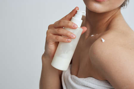 Bare shoulders white towel lotion for skin careの写真素材