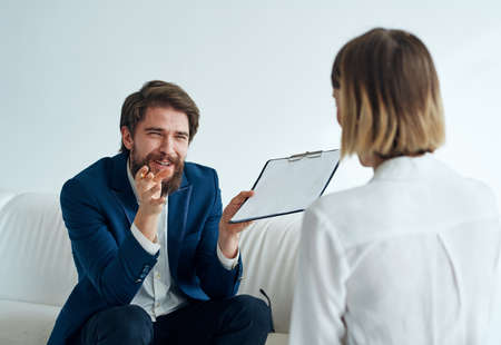 Men and women in suits of colleagues at work office communicatingの写真素材