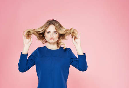 Beautiful woman elegant style blue dress lifestyle emotions pink backgroundの写真素材