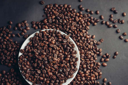 white saucer coffee cup on a gray table close-upの写真素材