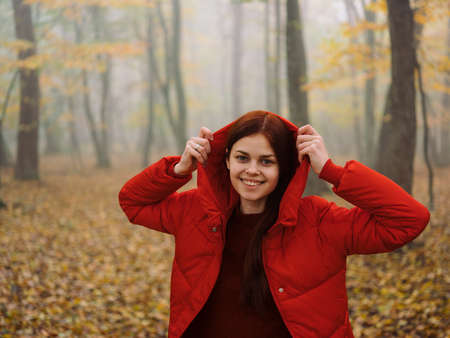 Woman red jacket with a hood rain Fog autumn yellow leavesの写真素材