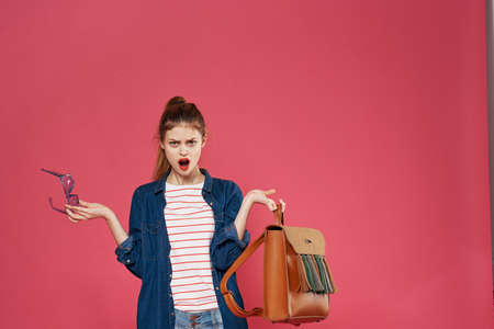 Glamorous woman fashionable clothes glasses cosmetics pink background