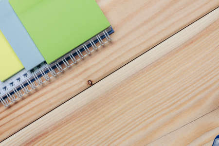 colorful notepads and pencils stationery wooden background close-upの写真素材
