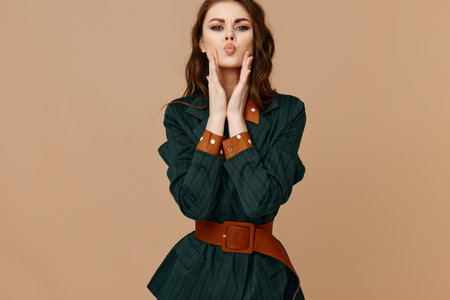 pretty woman in suit cropped view beige glamor backgroundの写真素材