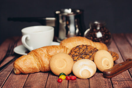 sweets for tea croissants cookies on a wooden table snackの写真素材