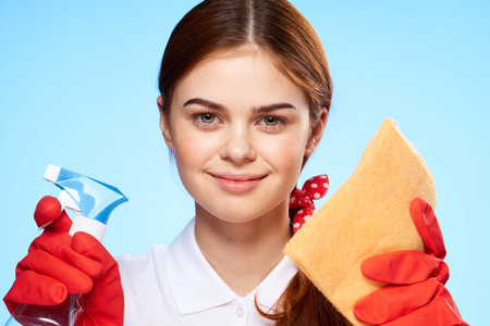 professional cleaning lady detergent rags service blue backgroundの写真素材