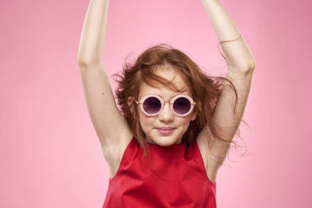 girl with curly hair sunglasses childhood joy pink background