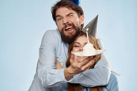 Birthday cake with candle man and woman corporate party fun holidaysの写真素材