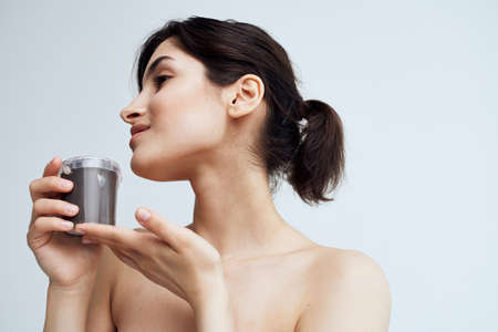 Pretty woman naked shoulders clean skin cream health procedureの写真素材