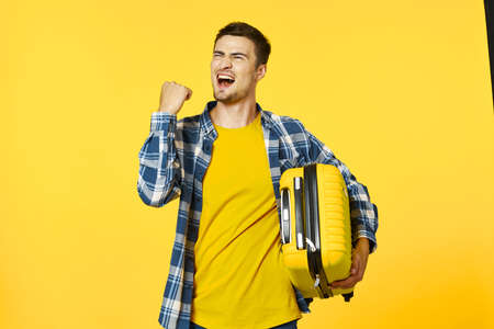 Cheerful male tourist with suitcase passenger vacation travelの写真素材