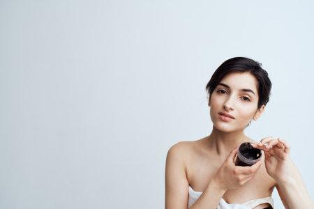 Pretty woman naked shoulders clean skin cream health procedureの写真素材