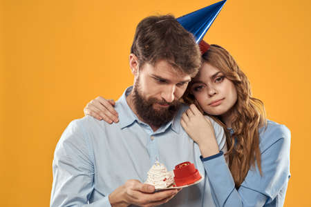 Birthday party man and woman fun yellow background cap holidayの写真素材