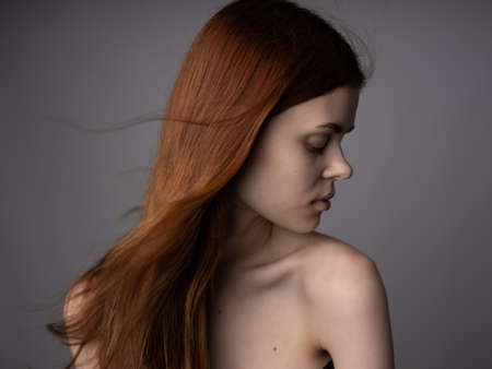 woman bare shoulders gray background loose hair model cropped viewの写真素材