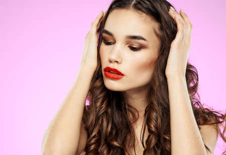 Romantic woman with red lips eye shadow and pink backgroundの写真素材