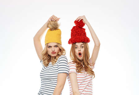 two women striped t-shirts colorful hats emotions fun fashion studio joyの写真素材
