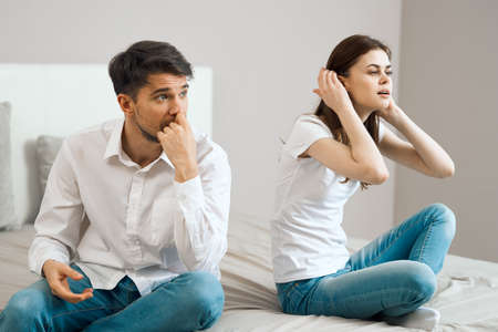 man and woman at home on the bed in the bedroom interior communication