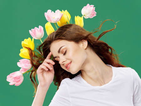woman with a bouquet of flowers Spring holiday Womens Day Green backgroundの写真素材