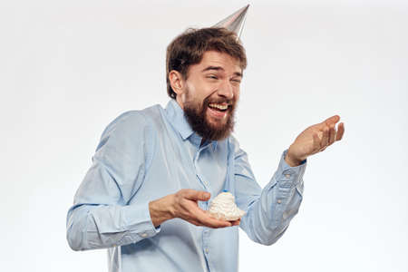 Happy guy with birthday cake white background Compact corporate party cropped beard viewの写真素材