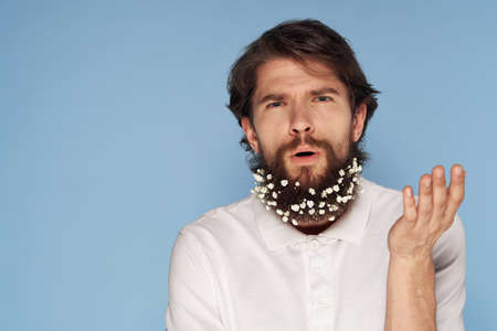 Man t-shirt flowers in beard decoration emotions blue background