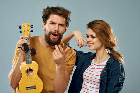 cheerful young couple ukulele music fun friendshipの写真素材