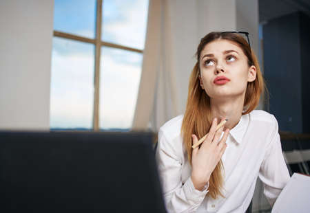 Woman secretary working desk laptop emotions office professional managerの写真素材