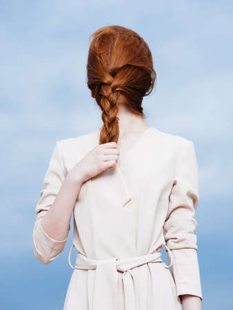 woman with hair on her face and in a sundress on a blue plan Modelの写真素材