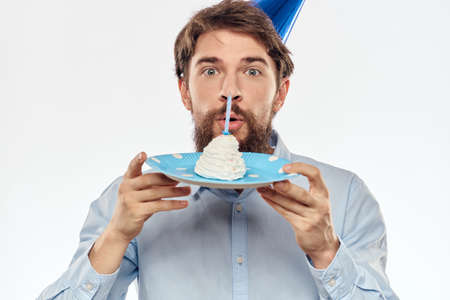 Happy guy with birthday cake white background Compact corporate party cropped beard viewの写真素材